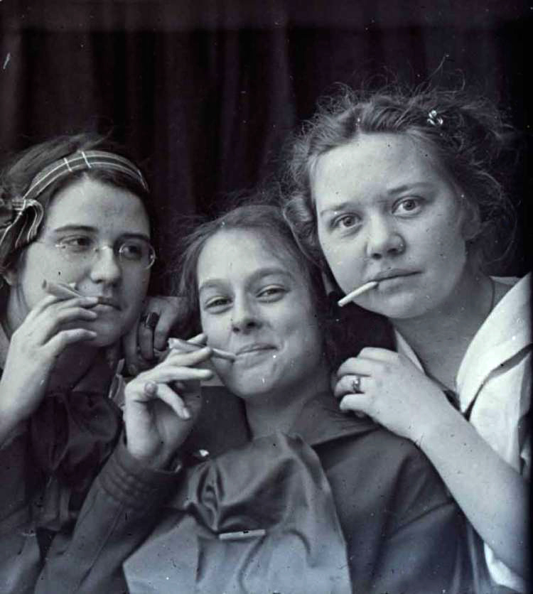 Three girls posing with cigarettes